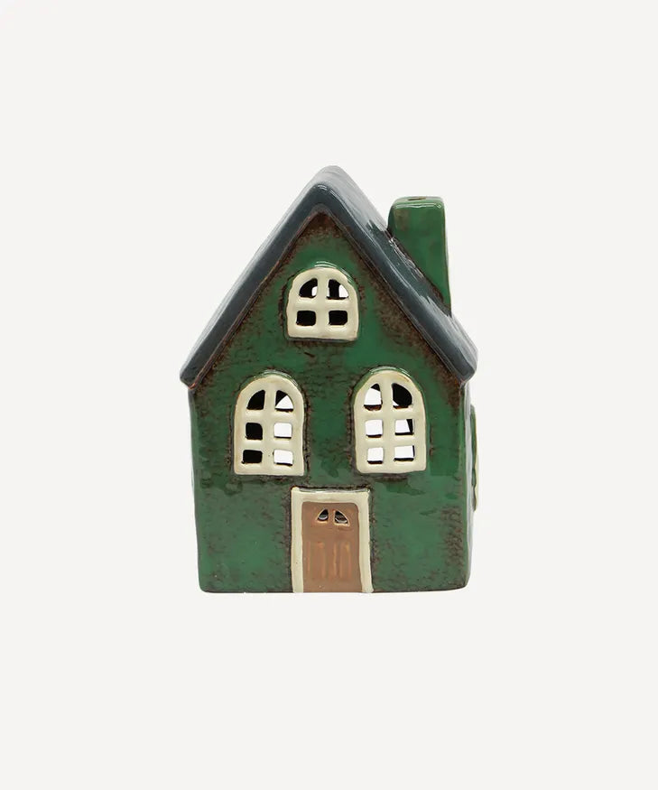 Green ceramic Christmas tealight barn styled in festive village scene