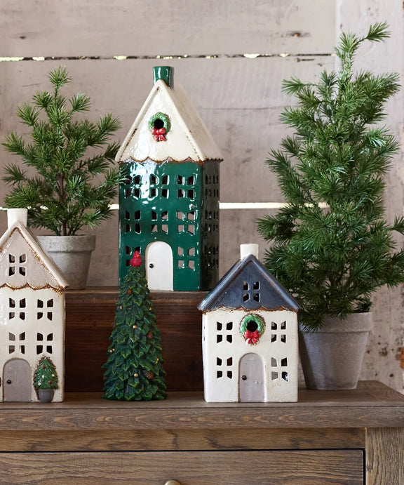 Small ceramic Christmas tea light house styled in holiday display