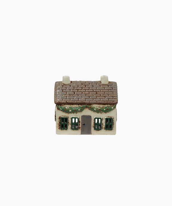 Festive ceramic cottage with decoration