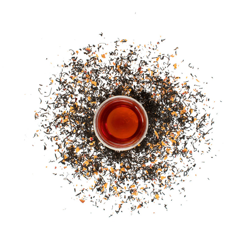 Tea cup with loose tea leaves on a white background. French Earl Grey Loose Leaf Tea - 50g Canister