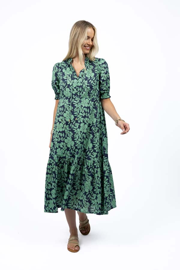 Flowing floral midi dress with puff sleeves and gathered waist, styled for summer