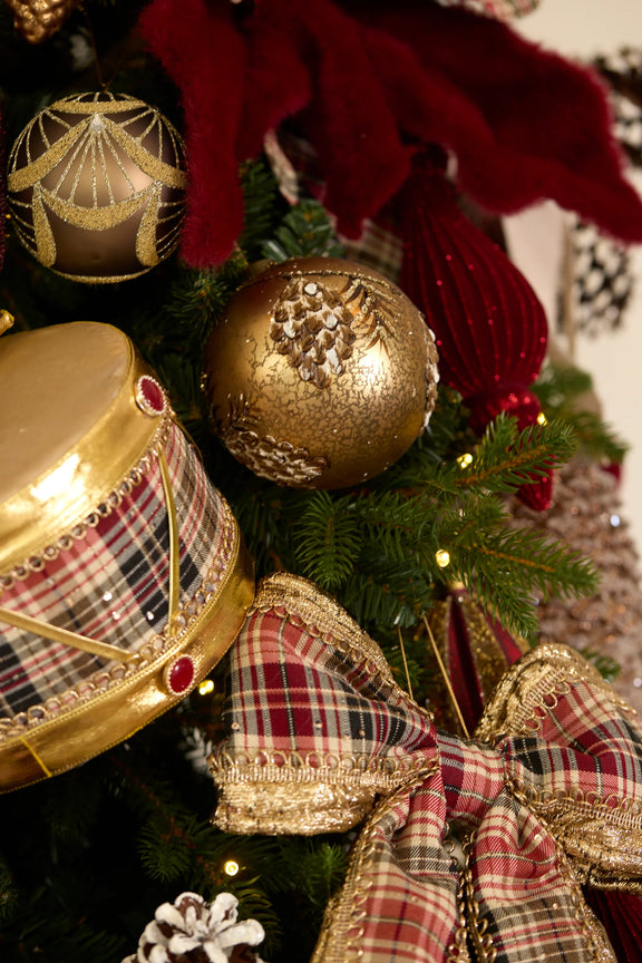 Large red and green tartan Christmas bow decoration – classic festive fabric bow for tree or wreath. Hanging on christmas tree.