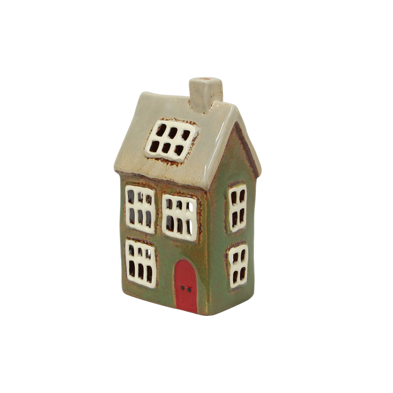 Hand-painted green tealight house styled in a Christmas village scene