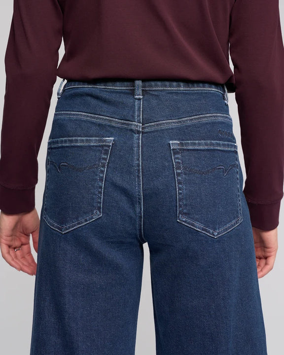 Women's dark blue stretch denim ankle grazer wide leg jeans.