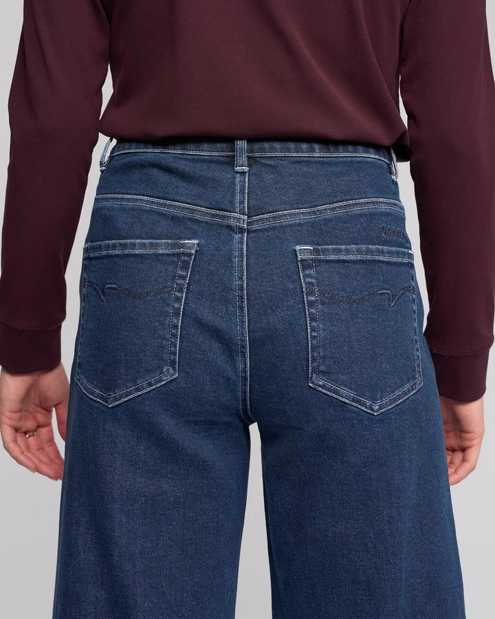 Women's dark blue stretch denim ankle grazer wide leg jeans.