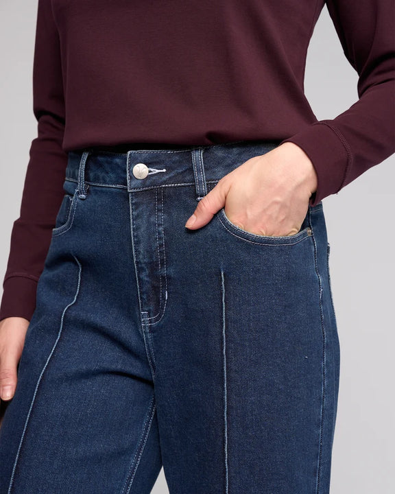 Women's dark blue stretch denim ankle grazer wide leg jeans.