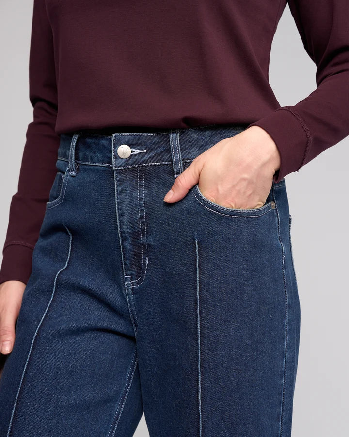 Women's dark blue stretch denim ankle grazer wide leg jeans.