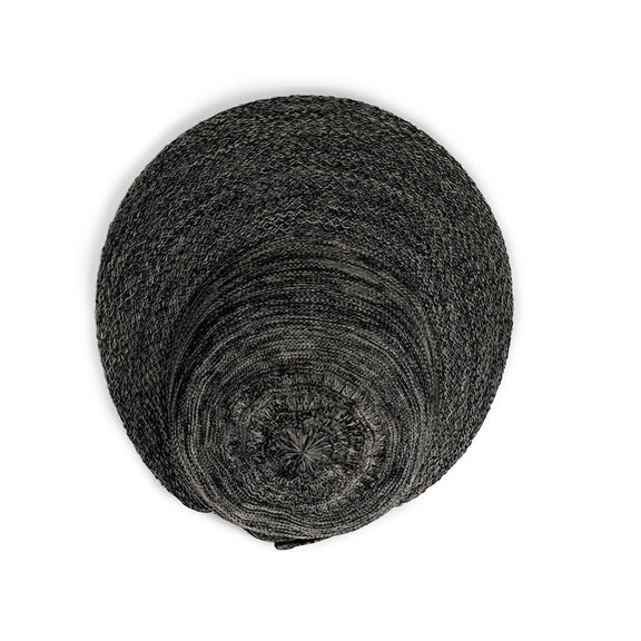 Stack of black circular coasters on a white background
