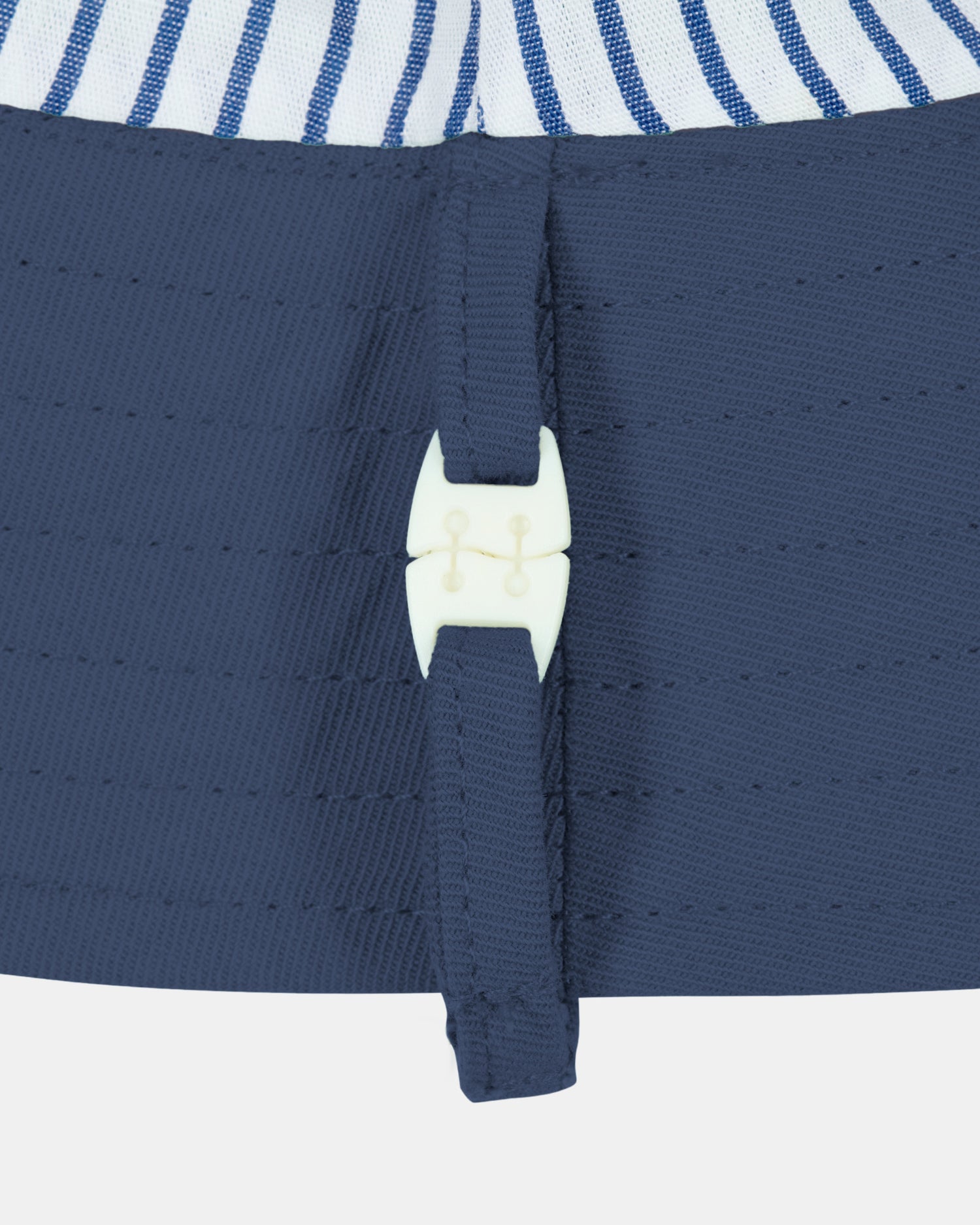 Toshi Midnight bucket hat with structured brim and safety clasp.