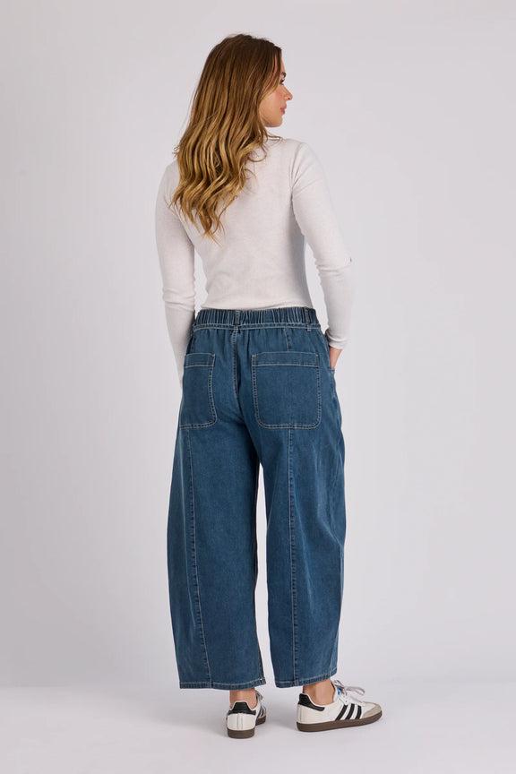 Relaxed fit barrel leg denim jeans in mid blue wash with contrast stitching and functional pockets.