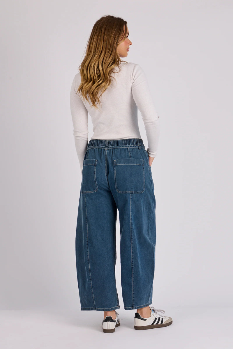 Relaxed fit barrel leg denim jeans in mid blue wash with contrast stitching and functional pockets.