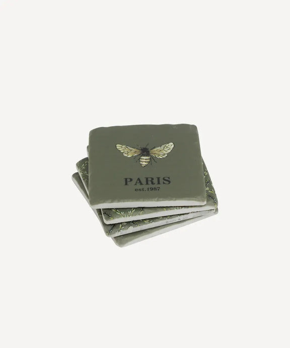 Set of four green bee coasters with bee design and 'PARIS' text on a white background