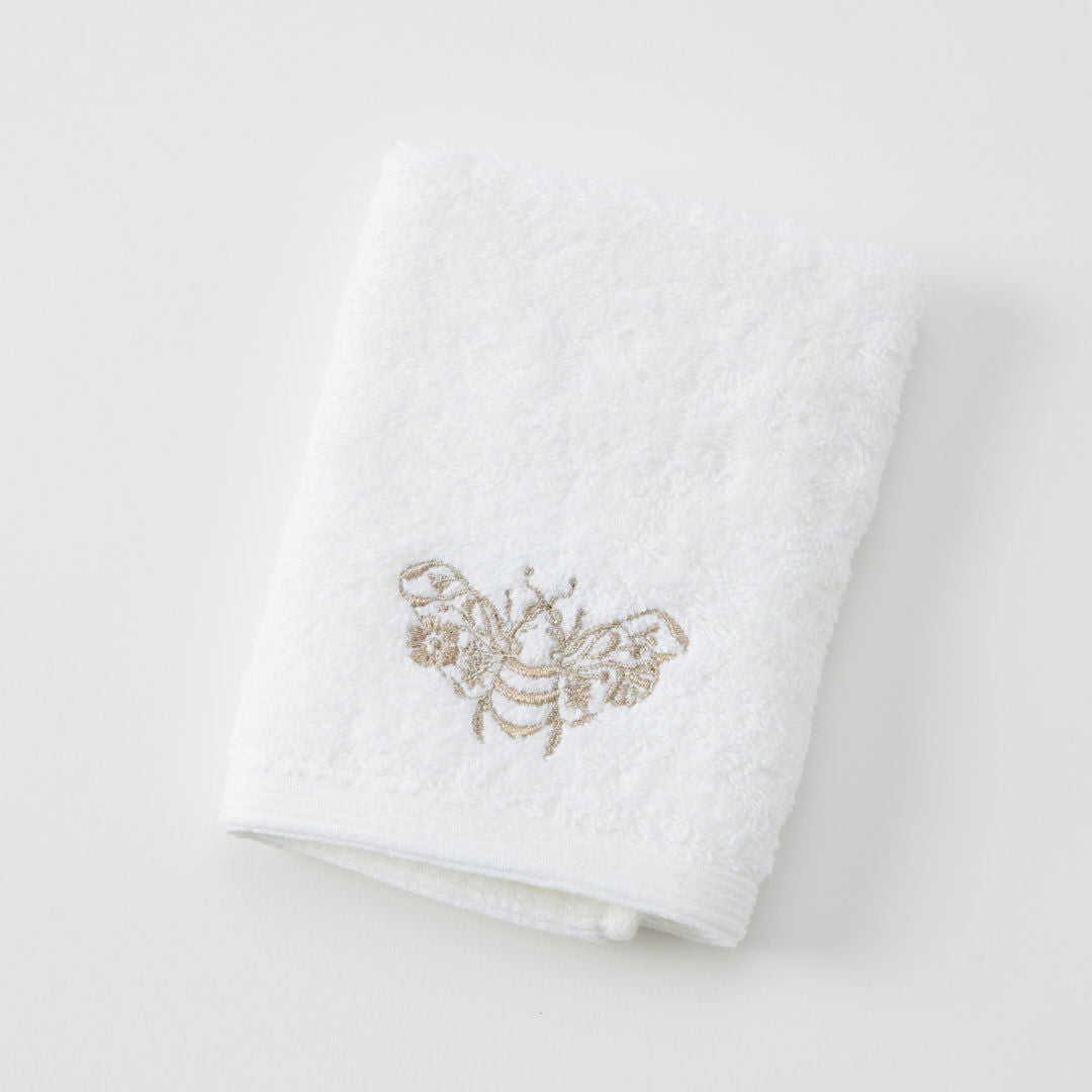 Beebee Face Washer in white and champagne with embroidered detail.