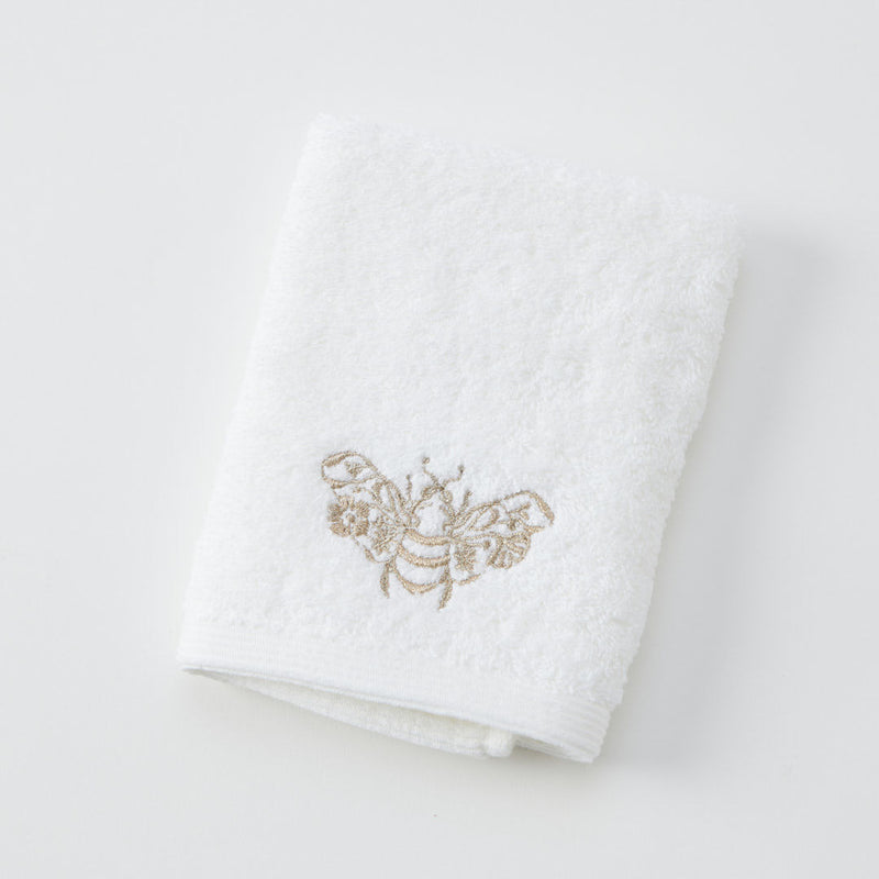 Beebee Face Washer in white and champagne with embroidered detail.