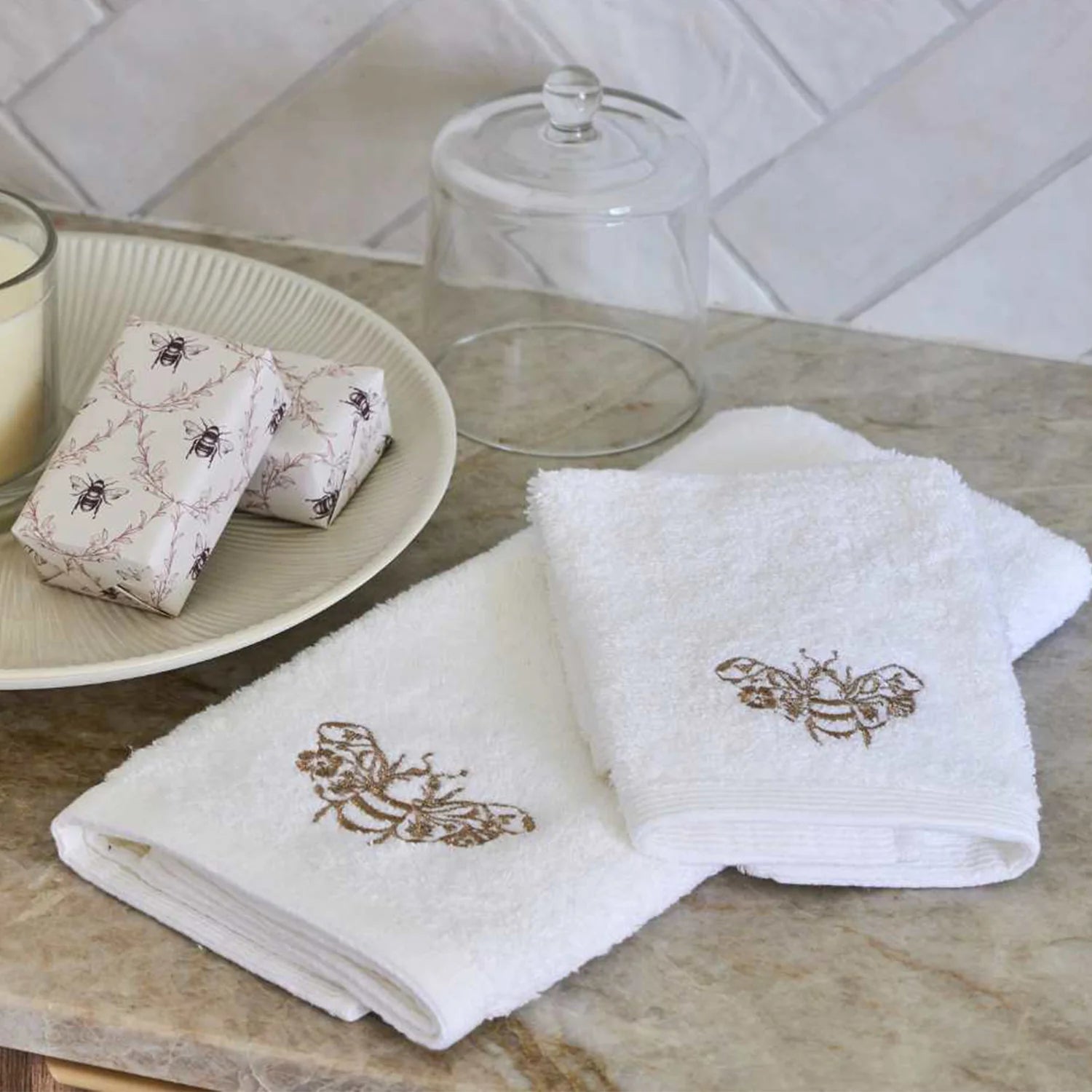 Beebee Hand Towel in white with champagne and gold embroidery.