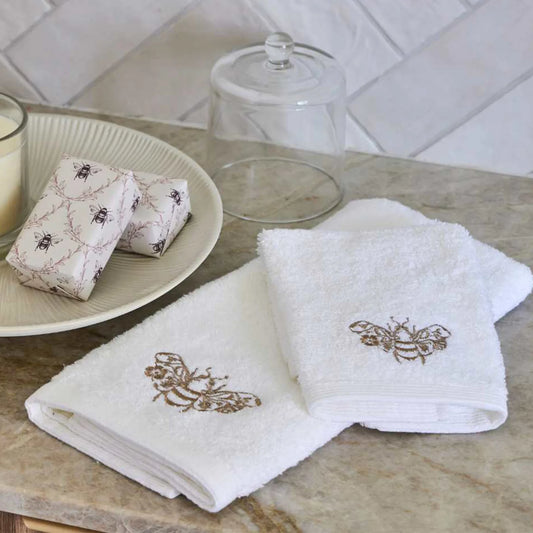 Beebee Hand Towel in white with champagne and gold embroidery.