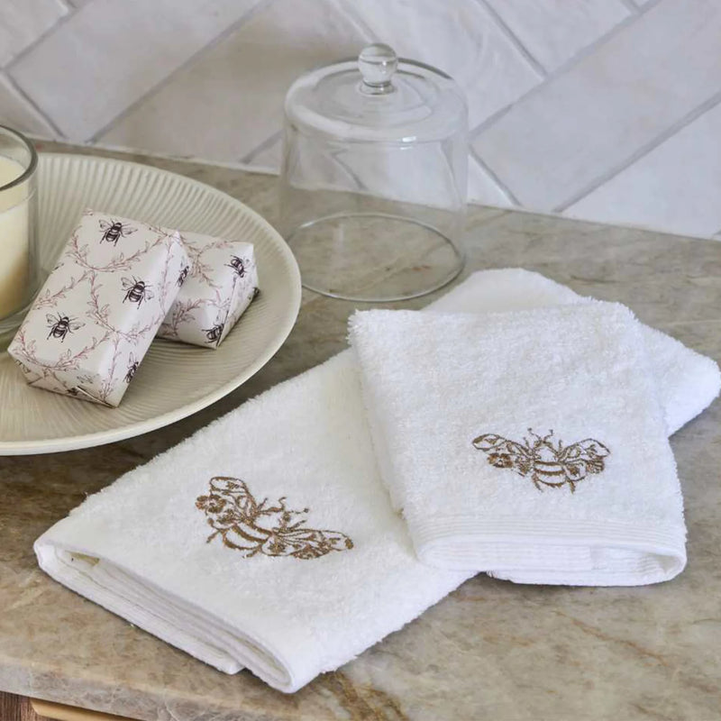 Beebee Hand Towel in white with champagne and gold embroidery.