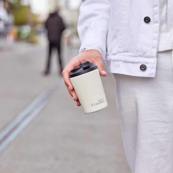 Reusable ceramic-lined coffee cup in Frost with insulated stainless steel body for everyday café drinks.