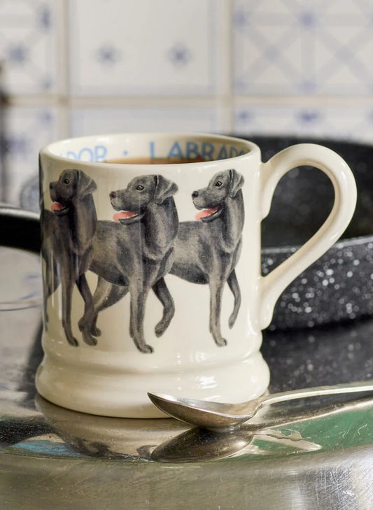 White earthenware mug featuring a Black Labrador design and classic Emma Bridgewater half pint shape.