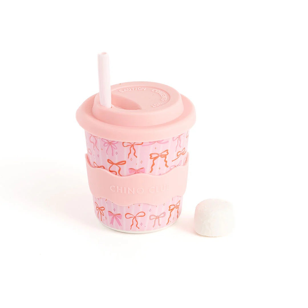 Pink tumbler with bow pattern on a white background. Bows Babychino Cup 8oz by Chino club.