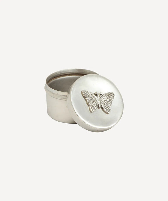 Decorative round aluminium trinket container featuring a butterfly