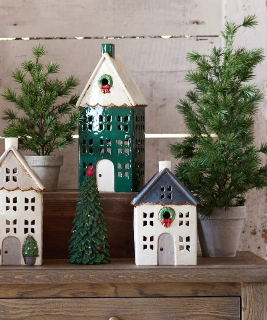 Small ceramic Christmas tea light house styled in holiday display