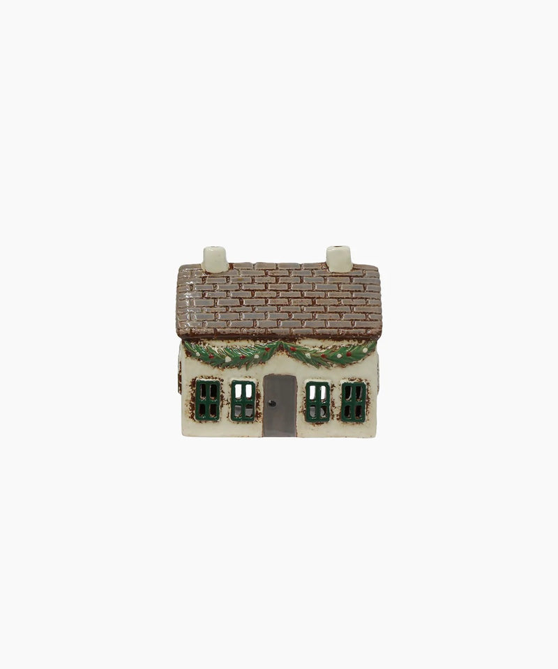 Festive ceramic cottage with decoration