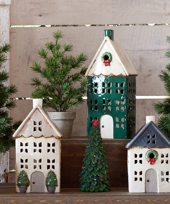Tall Christmas tea light house styled with holiday décor