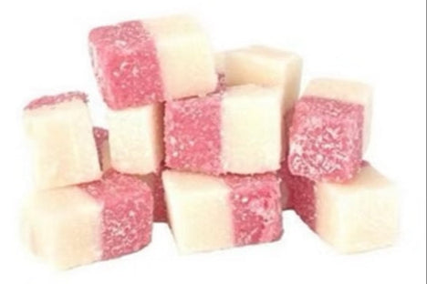 Pink and white coconut ice cubes dusted with coconut