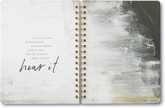 Open notebook with abstract design and inspirational quote on a white background