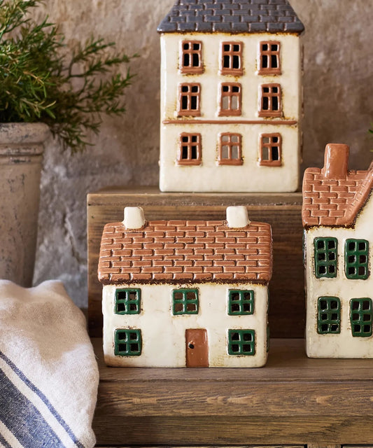 Rustic ceramic tea light cottage glowing with candle – Cotswolds style