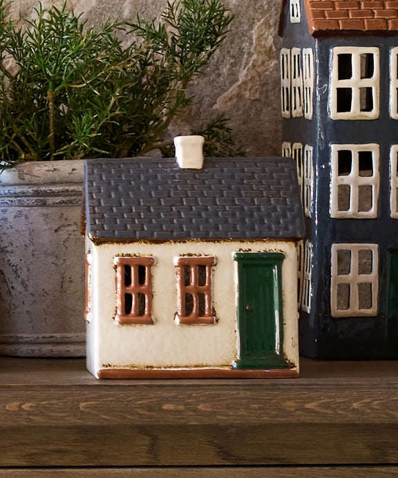 Rustic English countryside ceramic tea light homestead glowing with candle