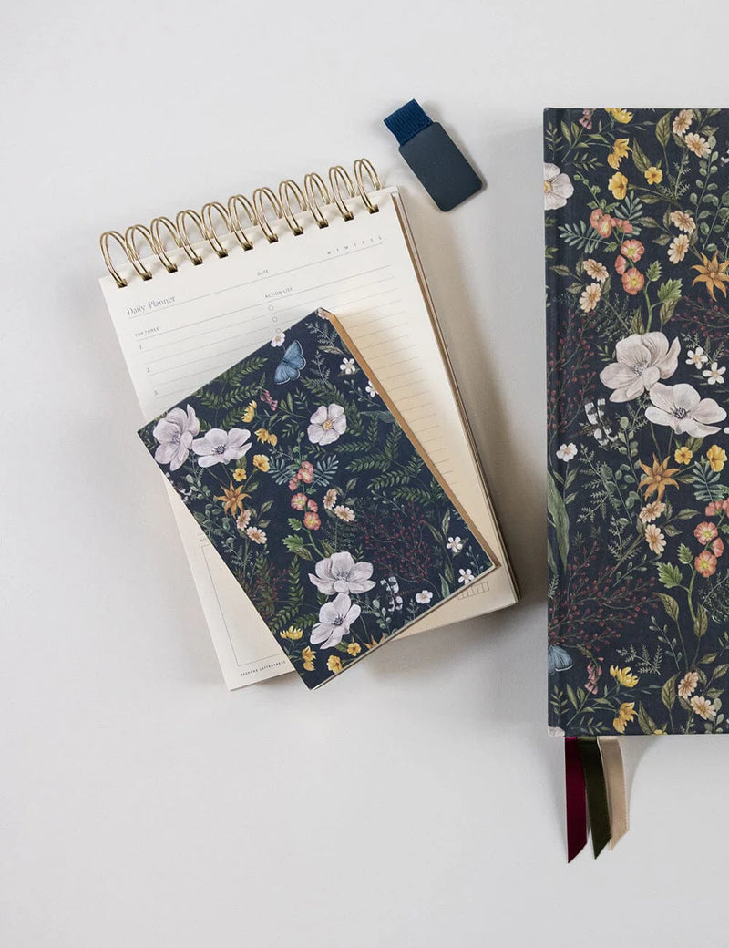 Compact floral notepad with heavyweight blank pages for notes, lists and ideas.