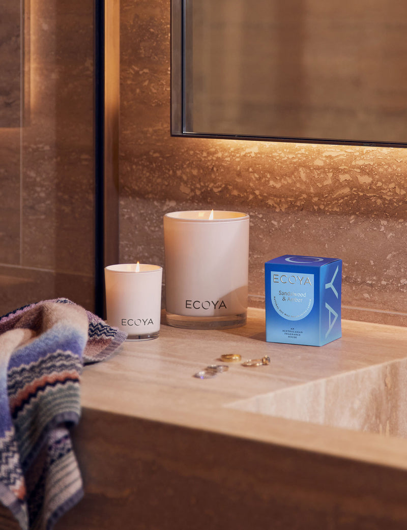 Sandalwood & Amber Mini Madison Candle styled in bathroom with full size madison ecoya candle