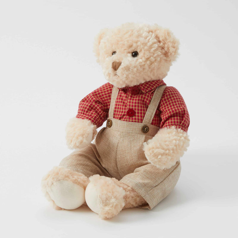 vintage style teddy bear with plaid shirt and overalls