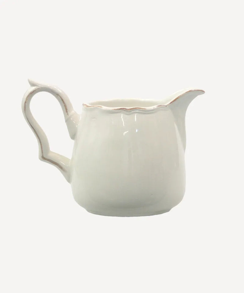 White ceramic milk jug with curved handle