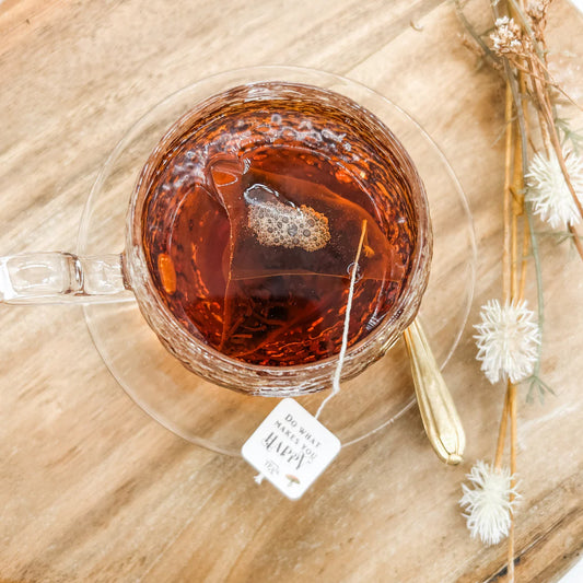 Close-up of black tea pyramid teabag and tag message