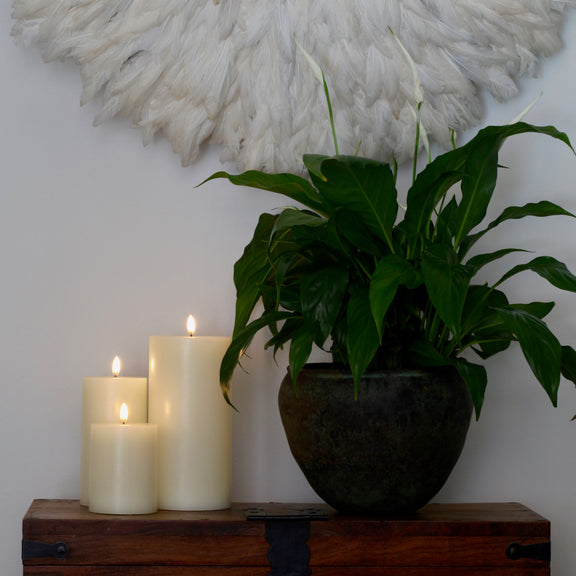 Uyuni Lighting 3D wick small pillar ivory - flameless candles styled next to a peace lilly