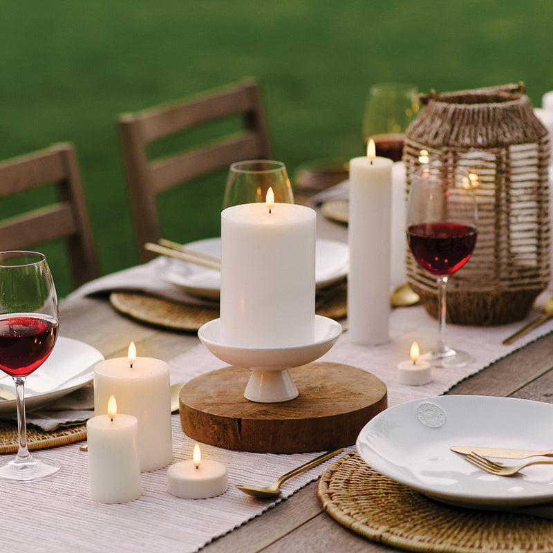 Uyuni Lighting 3D wick small pillar ivory - flameless candles styled on a dining table.