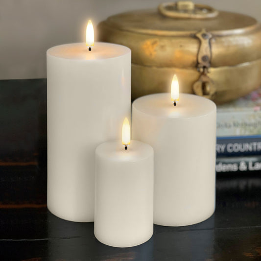 Flameless wax votive candle Uyuni Lighting styled alongside other flameless candles.