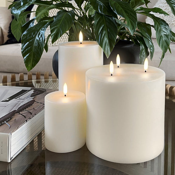 Flameless wax pillar candle Uyuni Lighting tall in living room with other flameless candles.