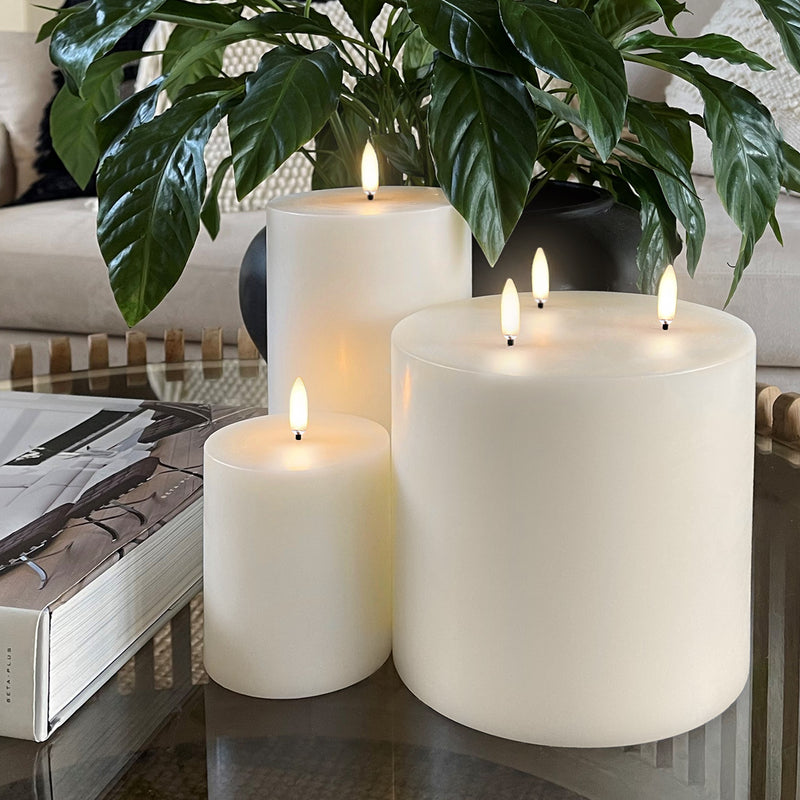 Flameless wax pillar candle Uyuni Lighting tall in living room with other flameless candles.