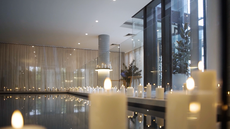flameless candles styled around an indoor pool