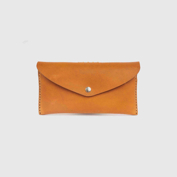 Brown leather wallet with a silver button on a light gray background