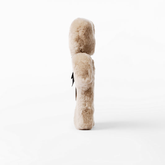 Soft sheepskin baby comforter flat teddy bear - side profile showing thickness. 