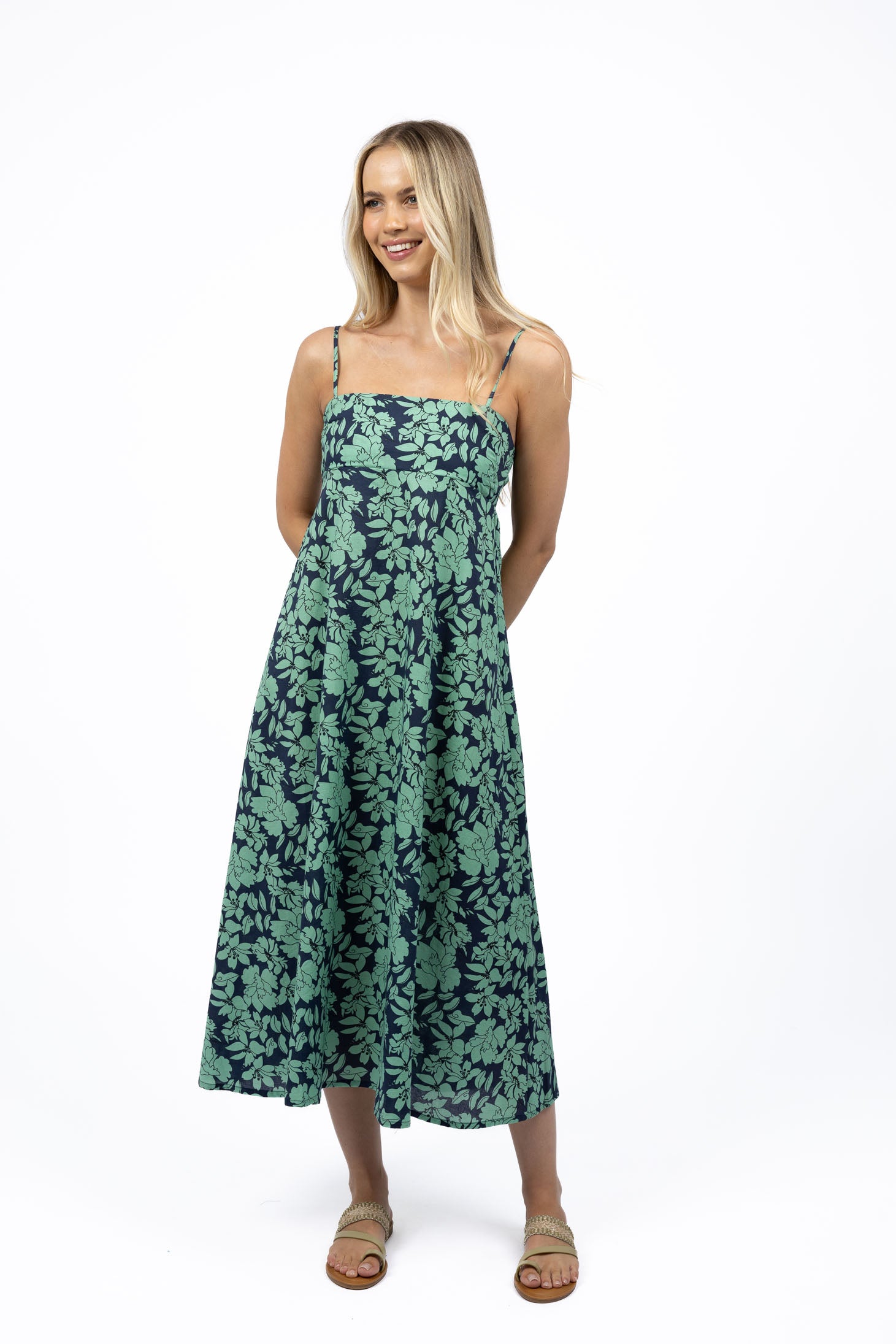 Woman wearing Humidity Fleur Sway Dress in floral print, strappy maxi style.