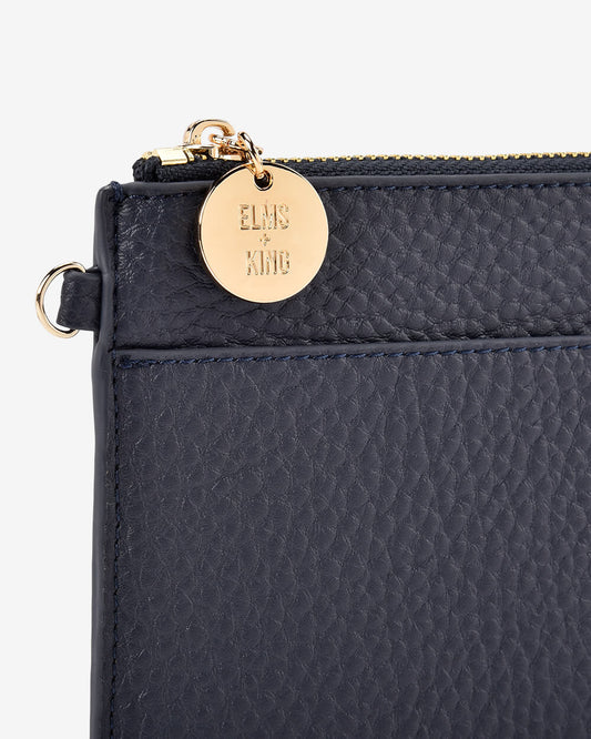 Navy Elms+King slim zip pouch with front slip pocket.