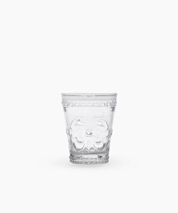 Clear glass tumbler with embossed fleur de lis pattern