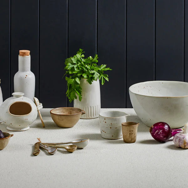 Small ceramic prep bowl with pour spout styled on kitchen bench