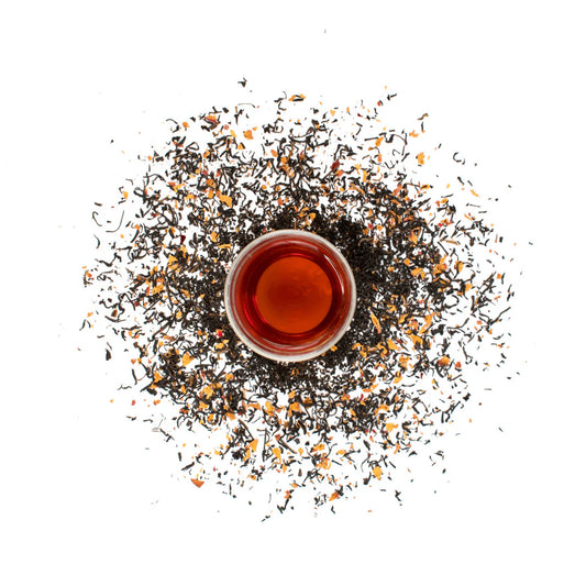 Tea cup with loose tea leaves on a white background. French Earl Grey Loose Leaf Tea - 50g Canister